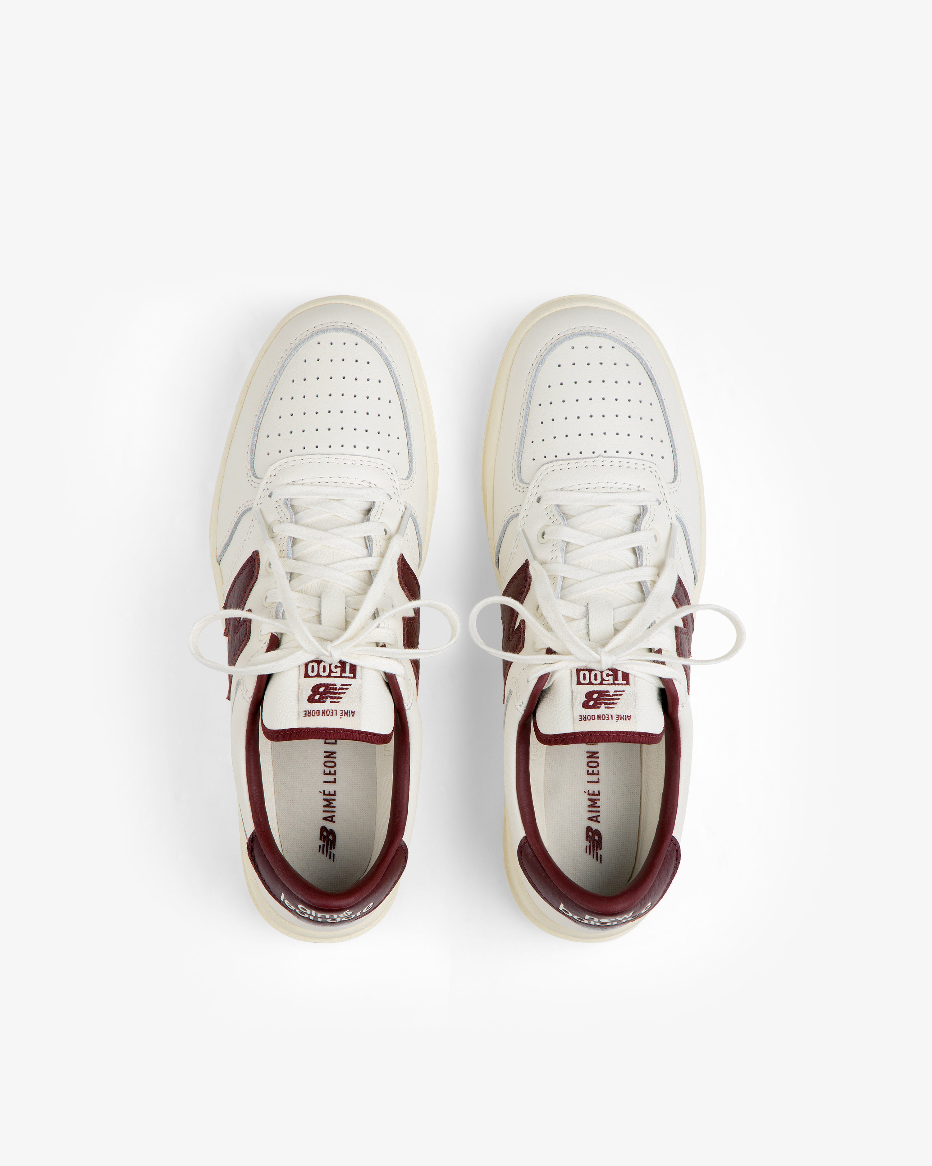 Top-down view of ALD / New Balance T500 Tennis Oxfords in off-white with burgundy accents and laces.
