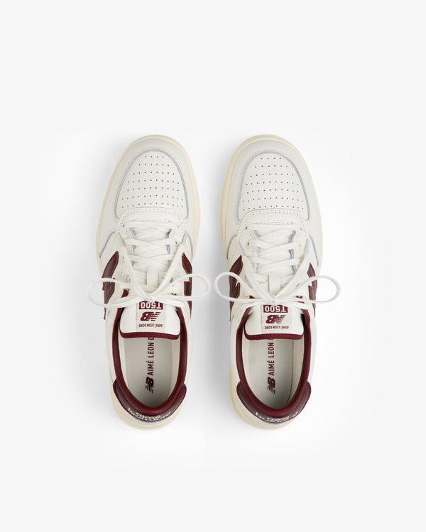 Top-down view of ALD / New Balance T500 Tennis Oxfords in off-white with burgundy accents and laces.
