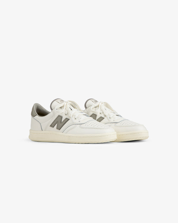 Off-white ALD / New Balance T500 Tennis Oxfords with a perforated toe box and grey logo patches.