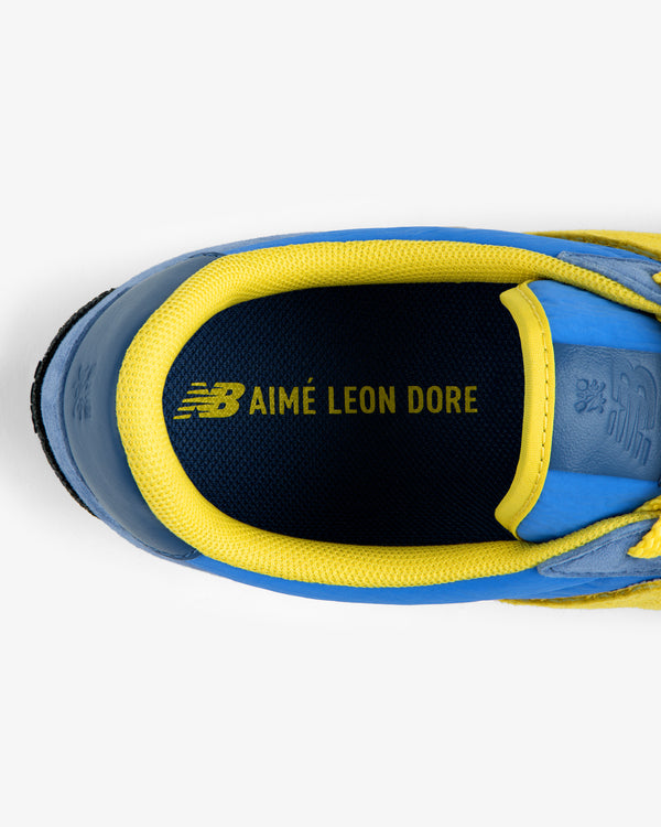 Blue and yellow ALD / New Balance Gator sneaker collar and insole featuring the Aimé Leon Dore logo.
