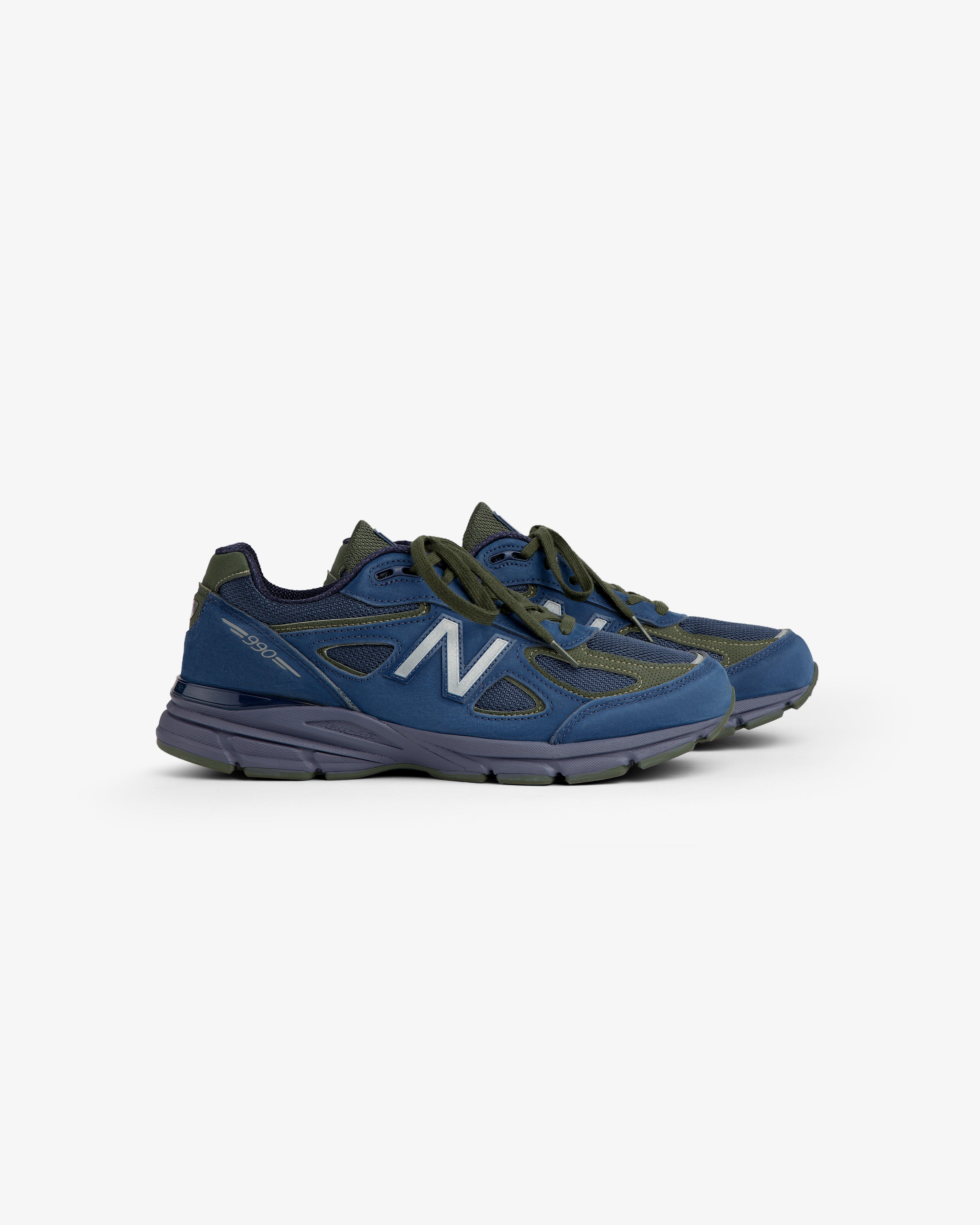 New Balance Made in USA 990v4 sneakers in blue/gray with black laces, displayed on a white background.