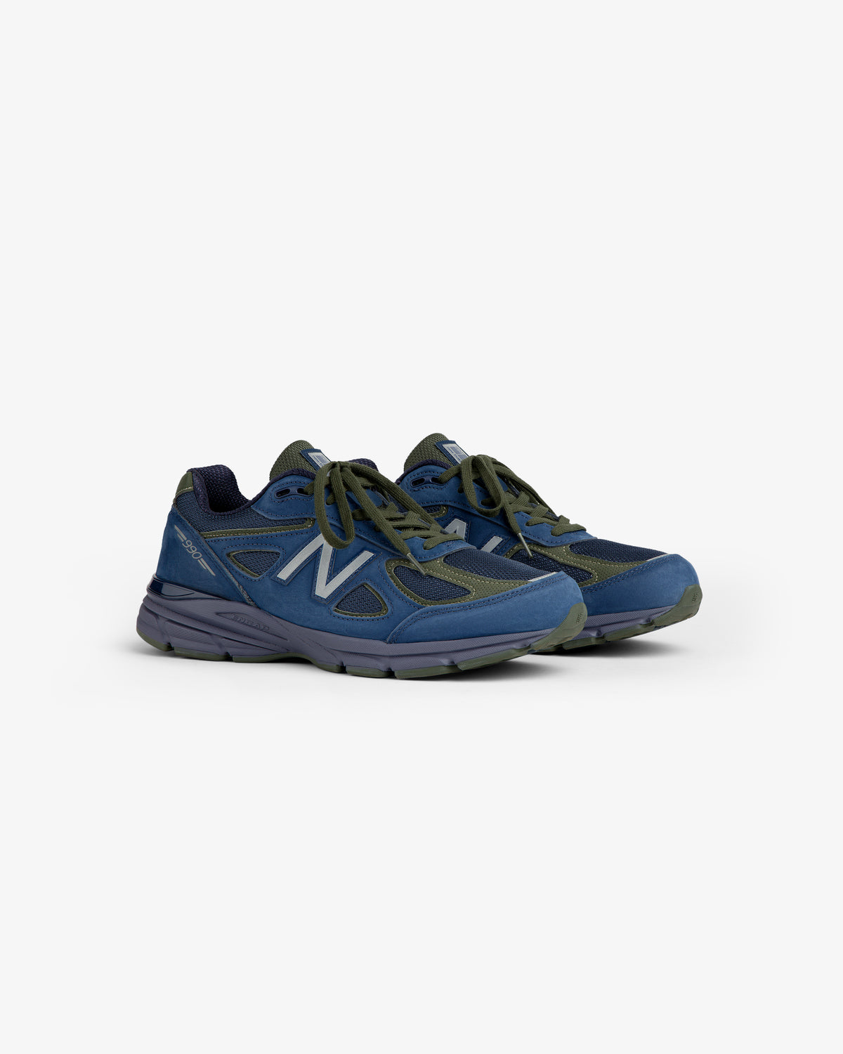 New Balance Made in USA 990v4 sneakers in blue and green with gray soles, shown on a white background.