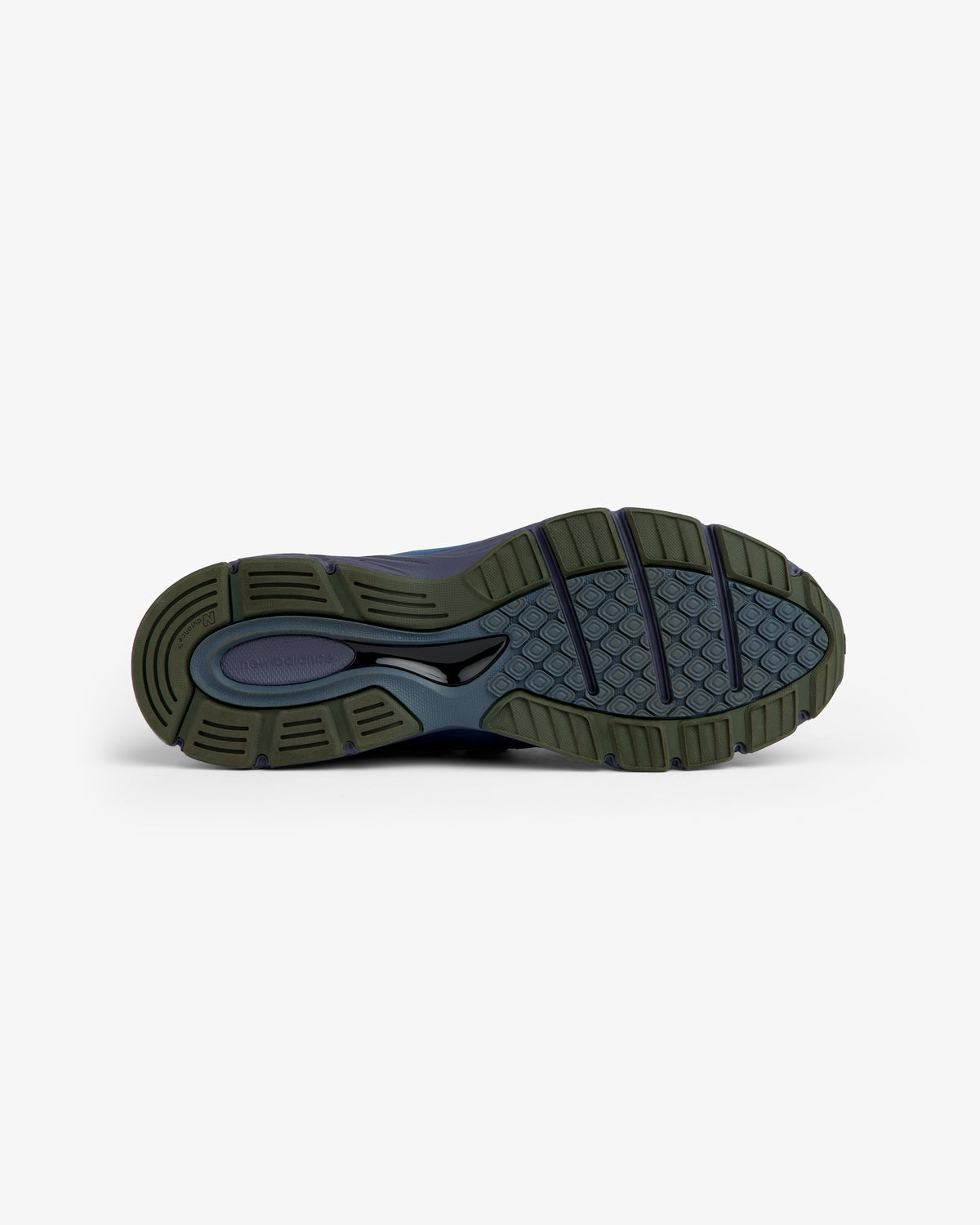 New Balance Made in USA 990v4 sneaker sole in dark blue/olive, shown from below with textured tread for grip.