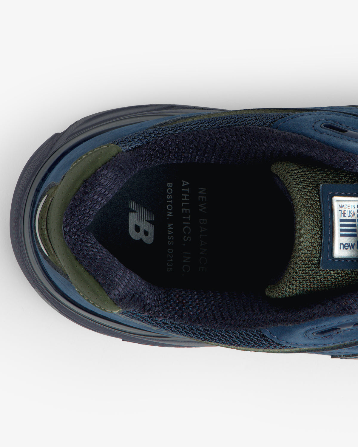 Top view of New Balance Made in USA 990v4 sneaker in blue/green, showing insole branding and label details.
