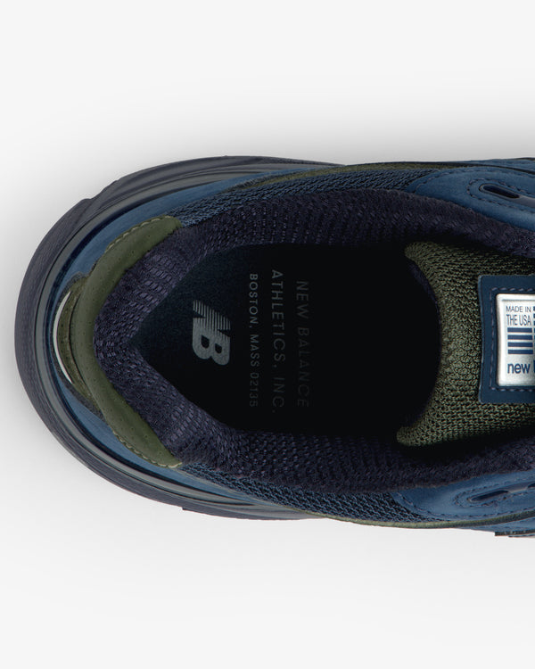 Top view of New Balance Made in USA 990v4 sneaker in blue/green, showing insole branding and label details.