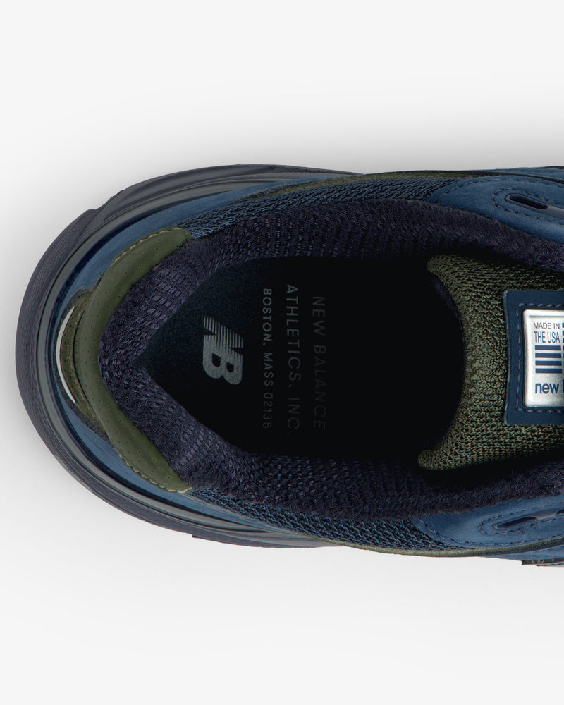 Top view of New Balance Made in USA 990v4 sneaker in blue/green, showing insole branding and label details.