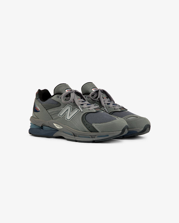 Gray New Balance Made in USA 2040v5 sneakers with mesh and suede, displayed on a white background.