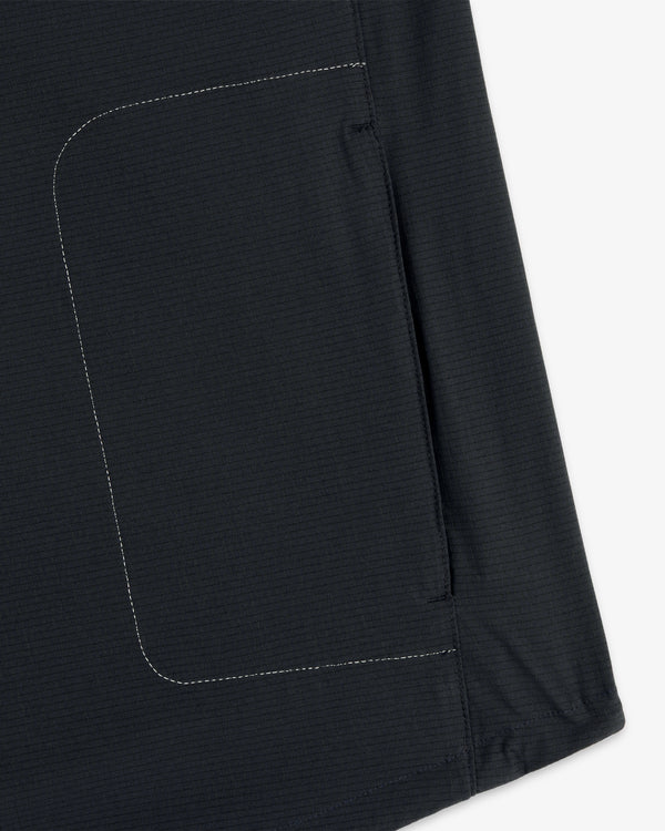 Close-up of the ALD / New Balance Performance Nylon Jacket’s dark fabric pocket with white side stitching.