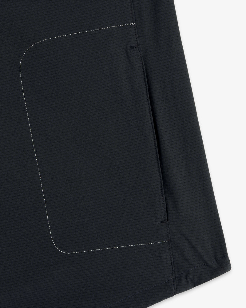 Close-up of the ALD / New Balance Performance Nylon Jacket’s dark fabric pocket with white side stitching.
