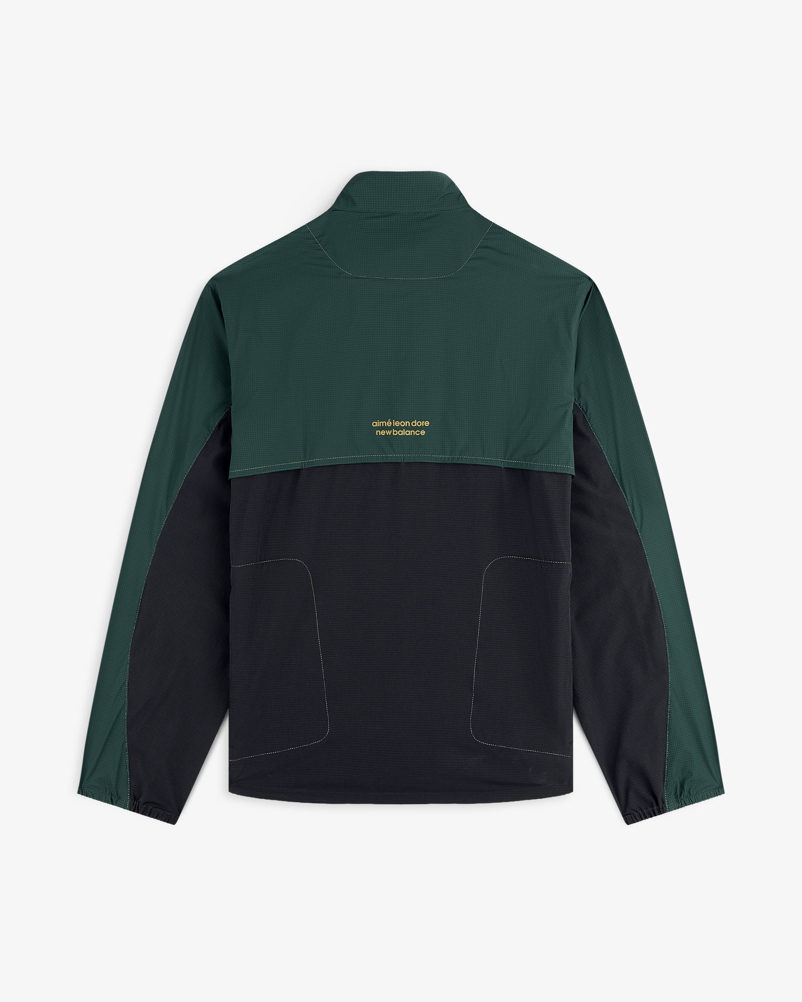 ALD / New Balance Performance Nylon Jacket with dark green sleeves/top, black bottom, and small yellow text on the back.