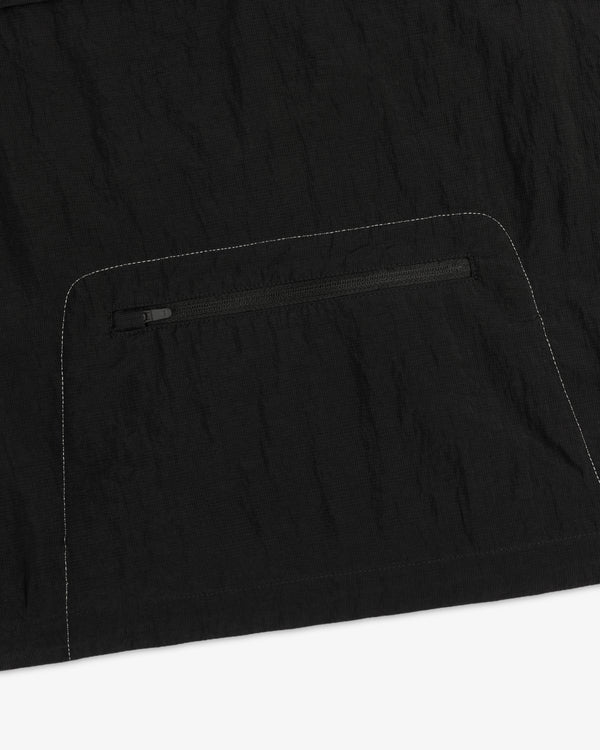 Close-up of the ALD / New Balance Breathable Half-Zip Pullover with a zip pocket and white stitching detail.