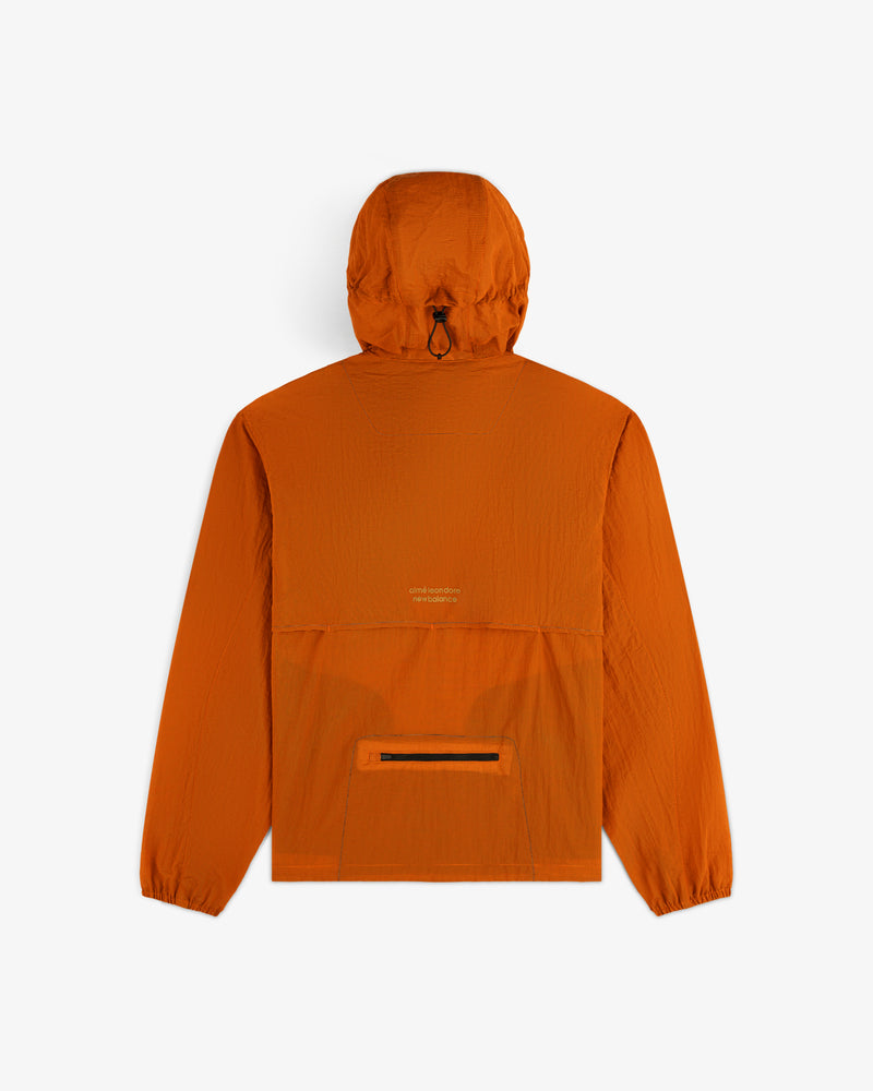 Back view of ALD / New Balance Breathable Half-Zip Pullover in orange, with center pocket and elastic cuffs on white.