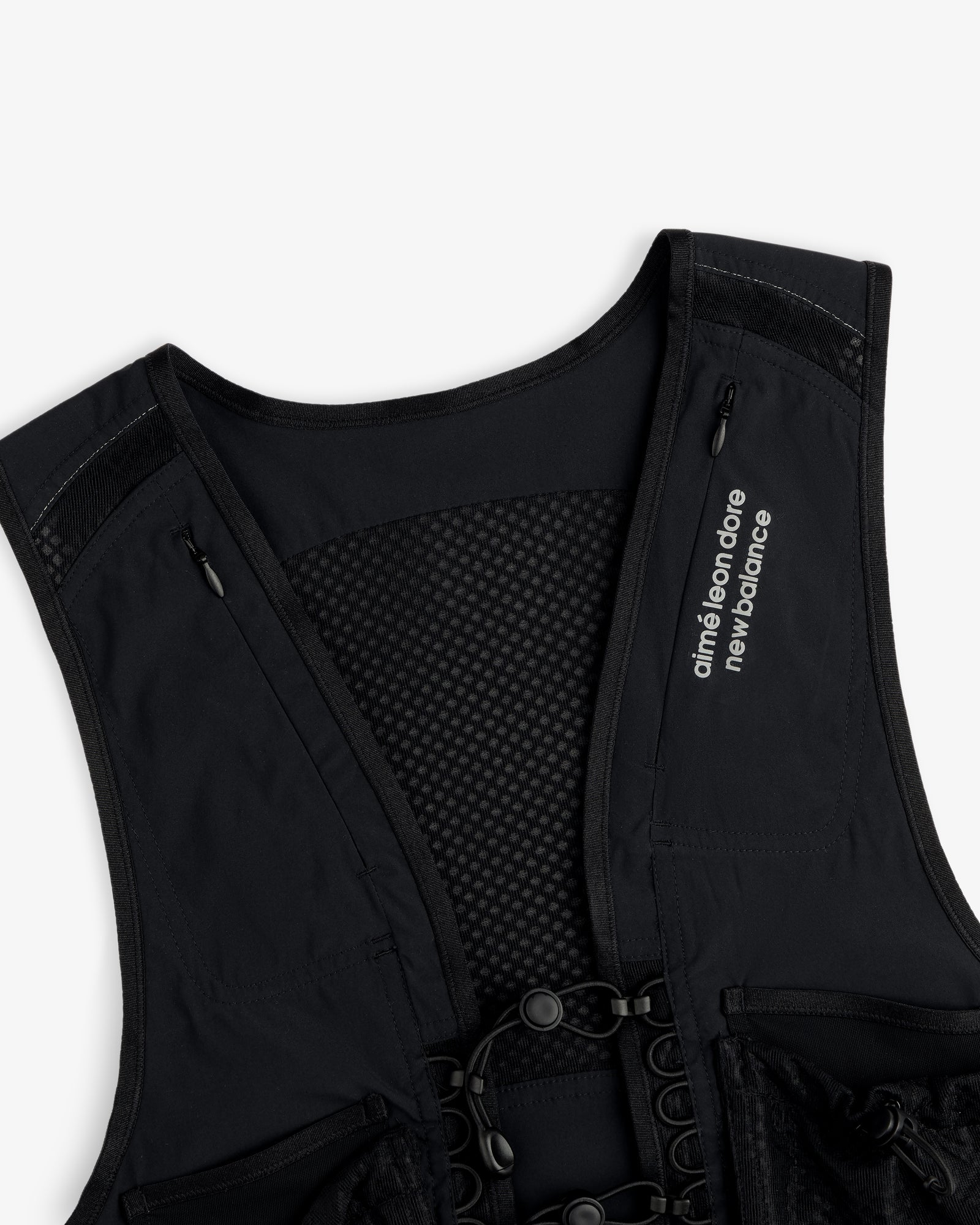 The ALD / New Balance Hydrovest features a mesh back and “aimé leon dore new balance” text on the left shoulder strap.
