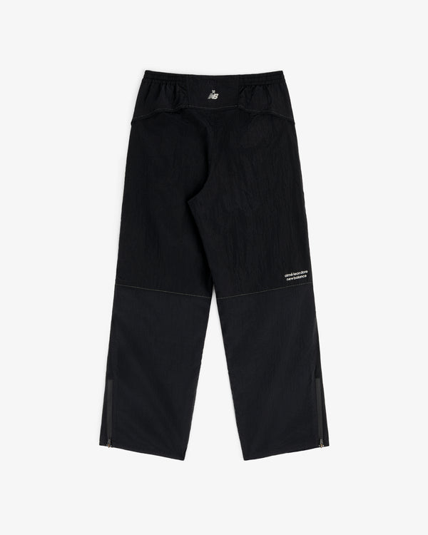 ALD / New Balance Lightweight Nylon Warmup Pant, black with ankle zippers and small white logo, displayed flat.