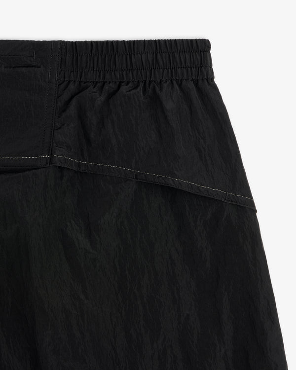 Close-up of ALD / New Balance Lightweight Nylon Warmup Pant with elastic waistband, textured fabric, and white stitching.