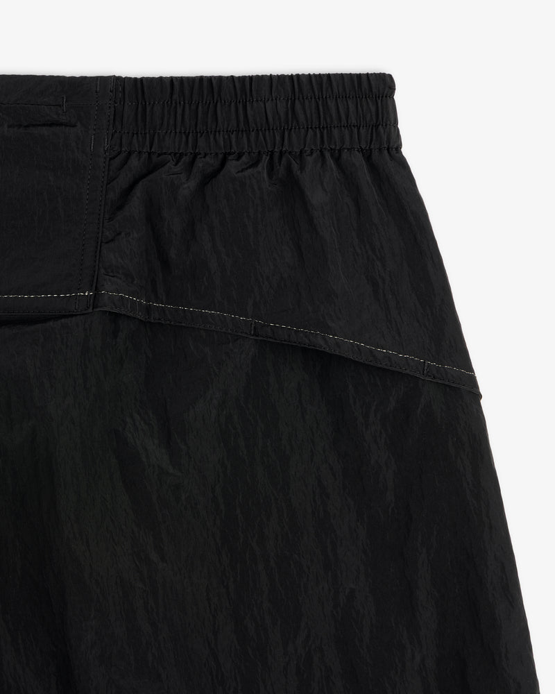 Close-up of ALD / New Balance Lightweight Nylon Warmup Pant with elastic waistband, textured fabric, and white stitching.