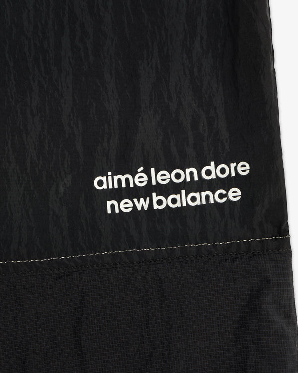 Black nylon ALD / New Balance Lightweight Warmup Pant with white branding and visible stitching at the hem.