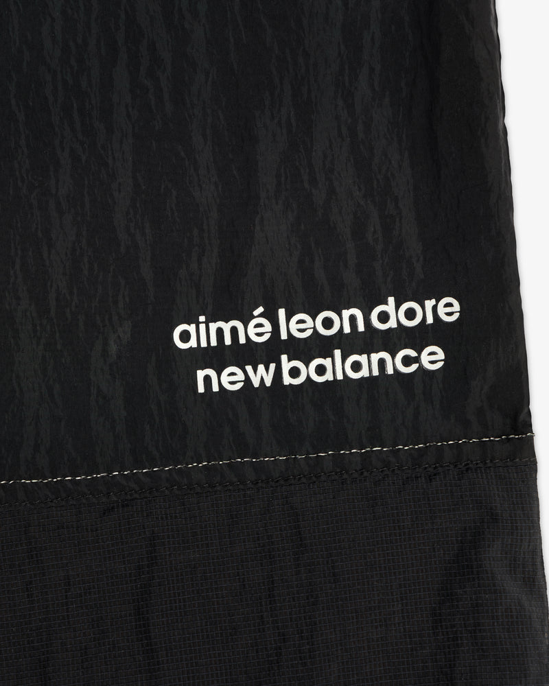 Black nylon ALD / New Balance Lightweight Warmup Pant with white branding and visible stitching at the hem.