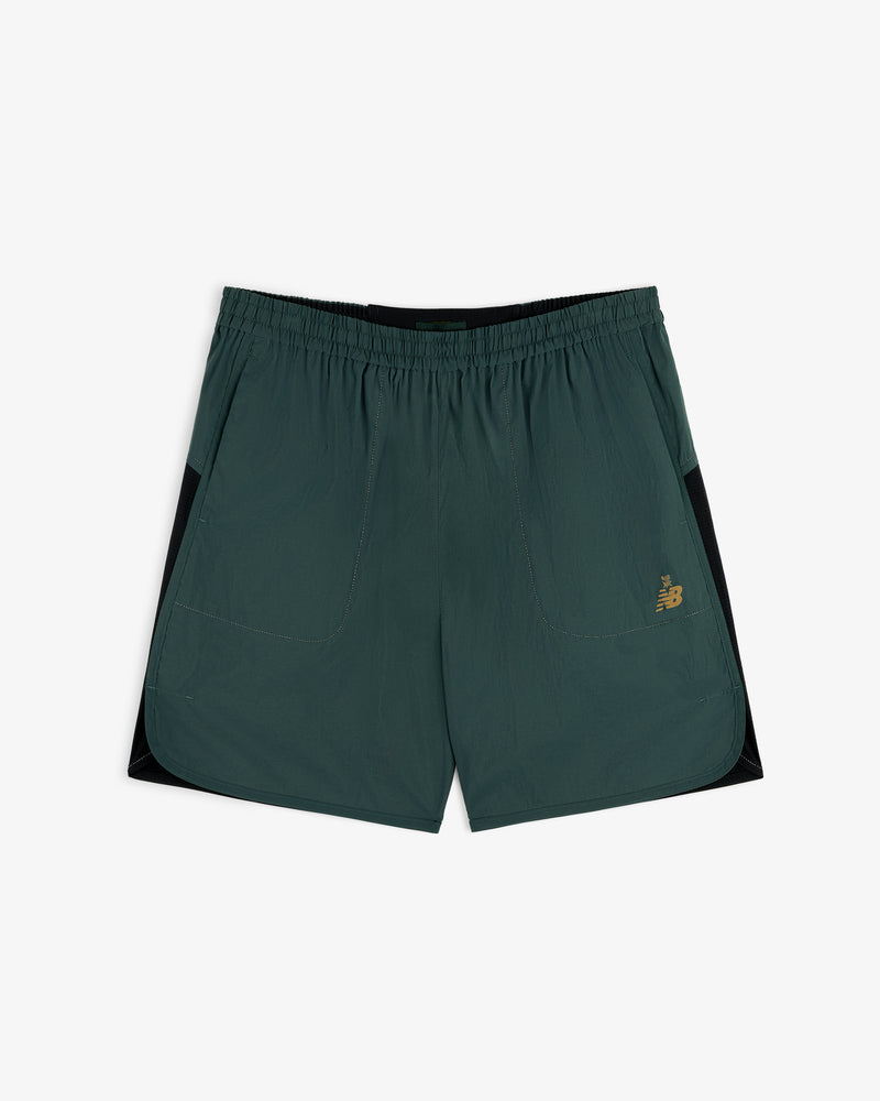 ALD / New Balance Performance Lightweight Running Short in dark green with black panels, pockets, and yellow logo.