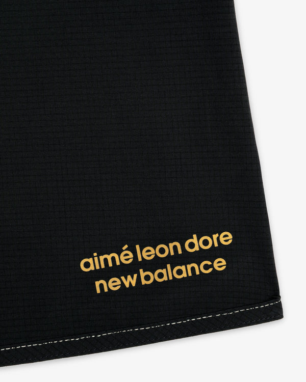 Close-up of black ALD / New Balance Performance Lightweight Running Short with yellow logo in the corner.
