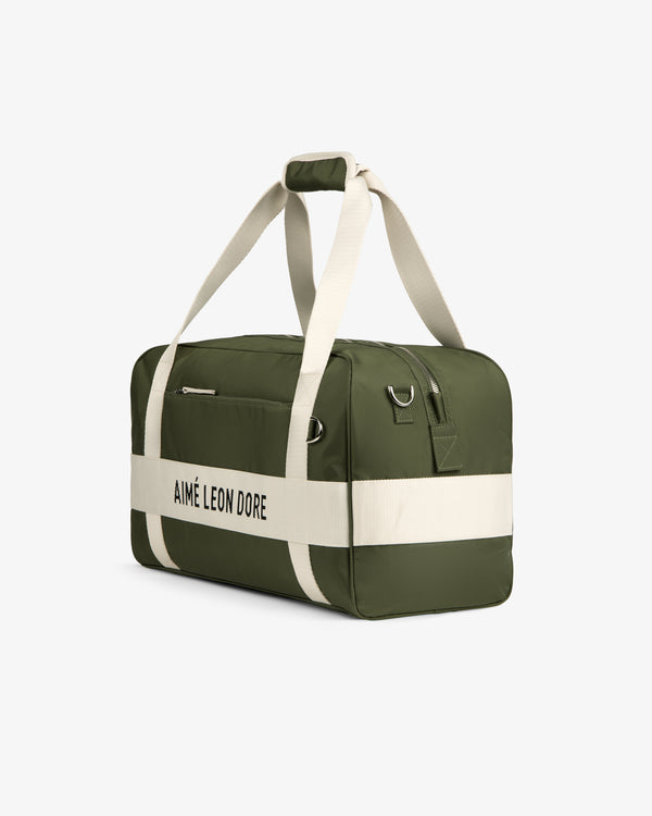 Olive green and cream Nylon Duffle Bag with AIMÉ LEON DORE text and cream handles, shown on a white background.