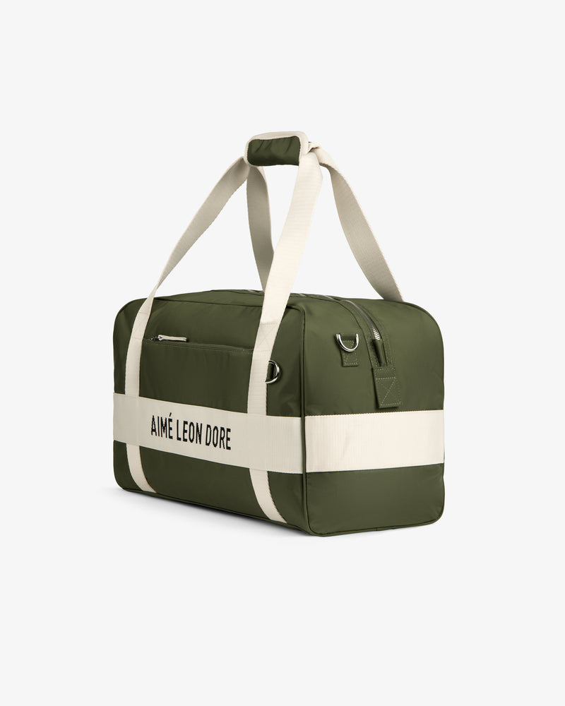 Olive green and cream Nylon Duffle Bag with AIMÉ LEON DORE text and cream handles, shown on a white background.