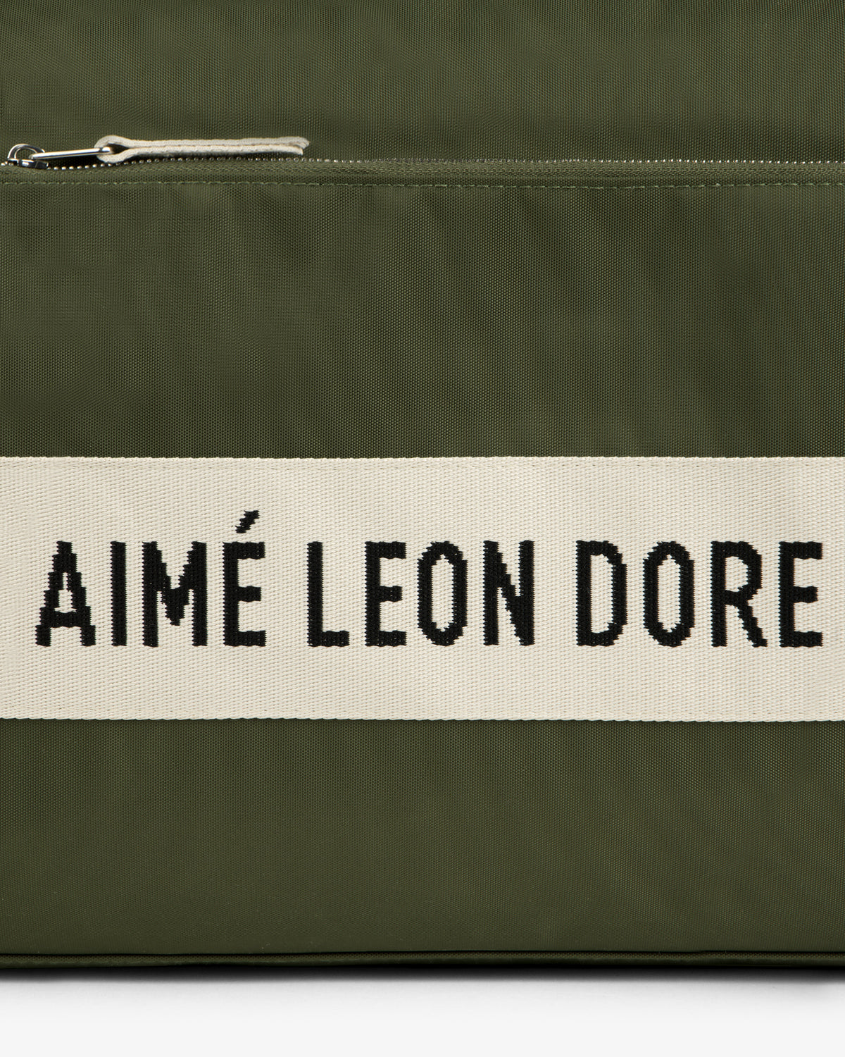 Olive green Nylon Duffle Bag with a white stripe featuring AIMÉ LEON DORE in bold black letters.