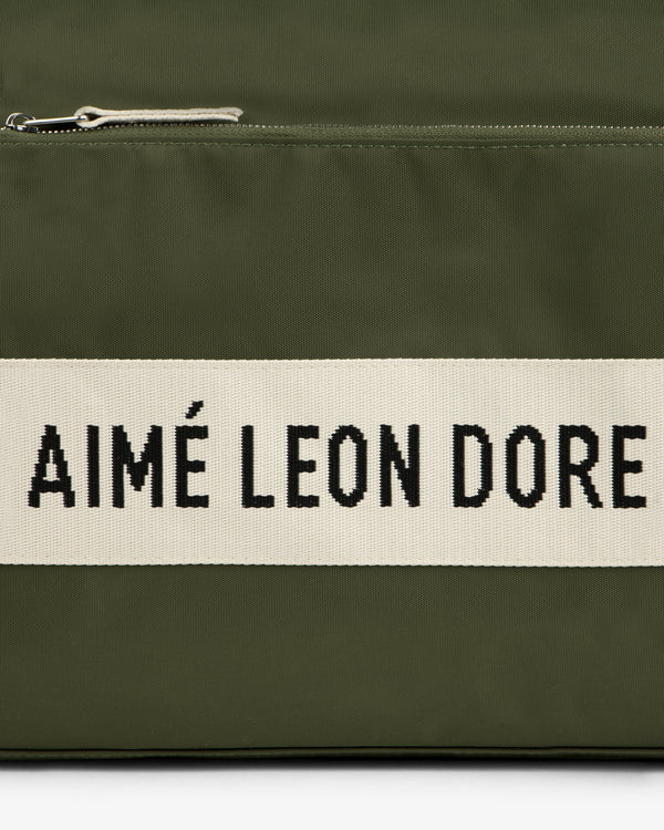 Olive green Nylon Duffle Bag with a white stripe featuring AIMÉ LEON DORE in bold black letters.
