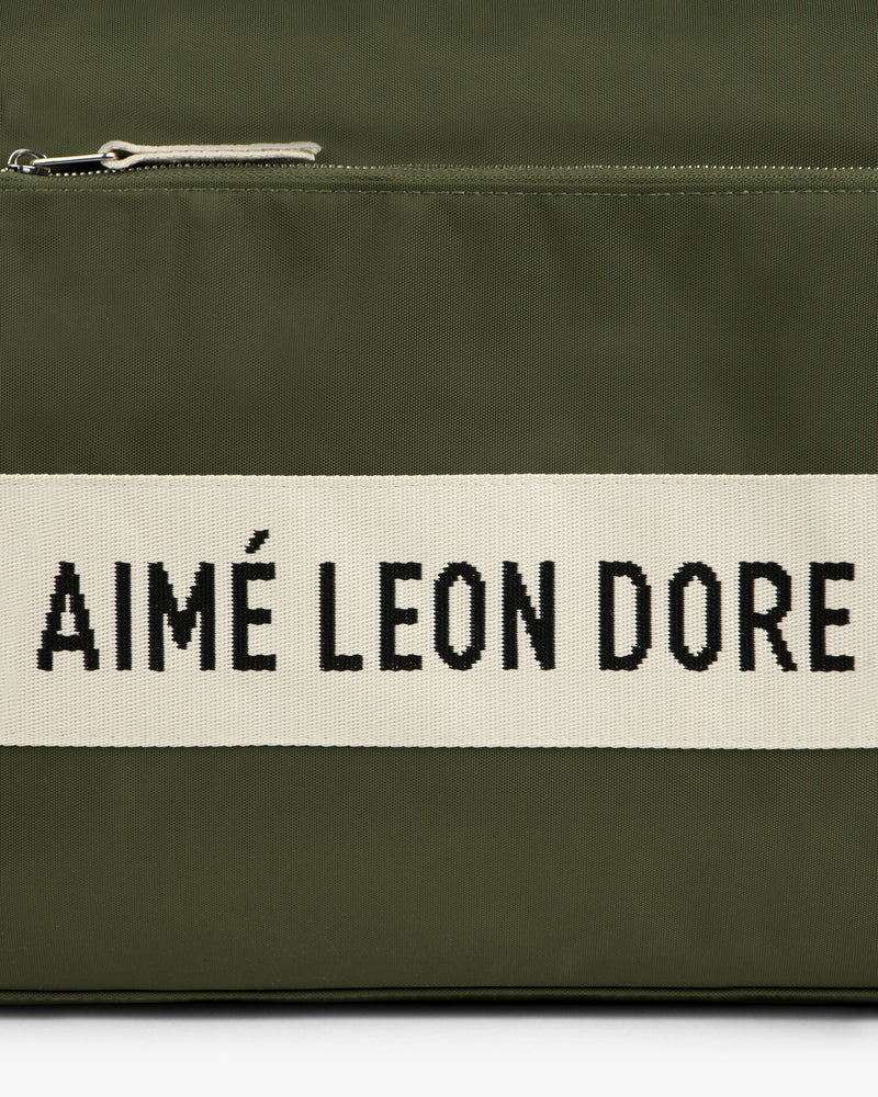 Olive green Nylon Duffle Bag with a white stripe featuring AIMÉ LEON DORE in bold black letters.