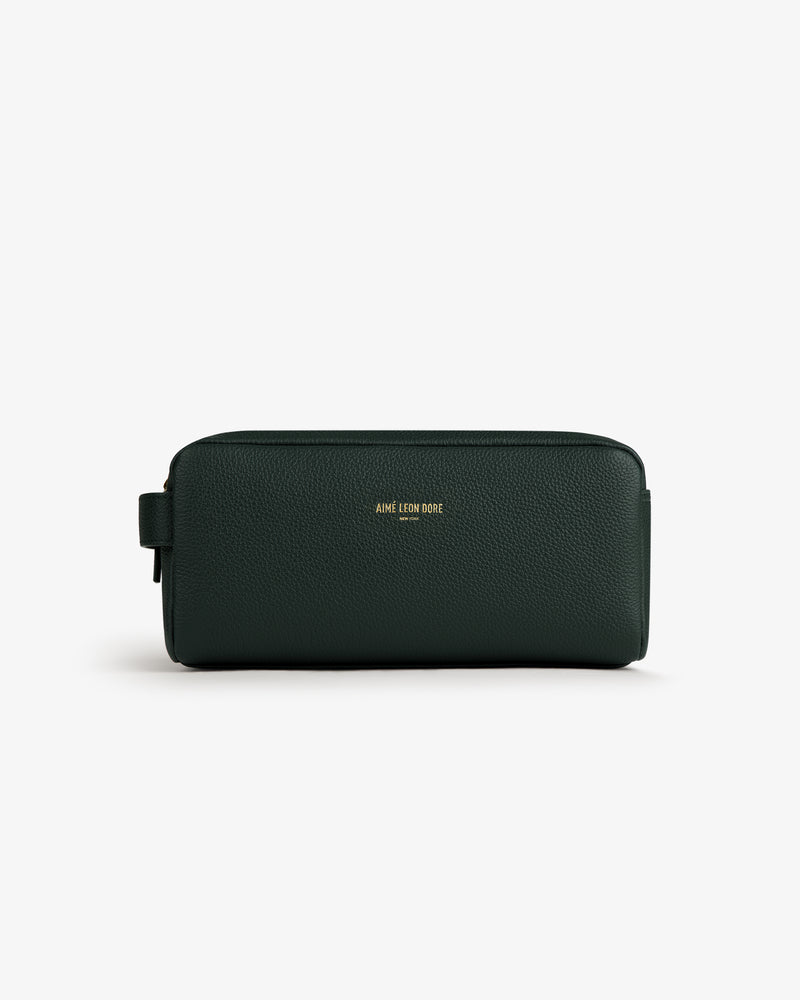 Dark green Leather Traveler Kit with gold AIME LEON DORE logo on front, shown against a white background.