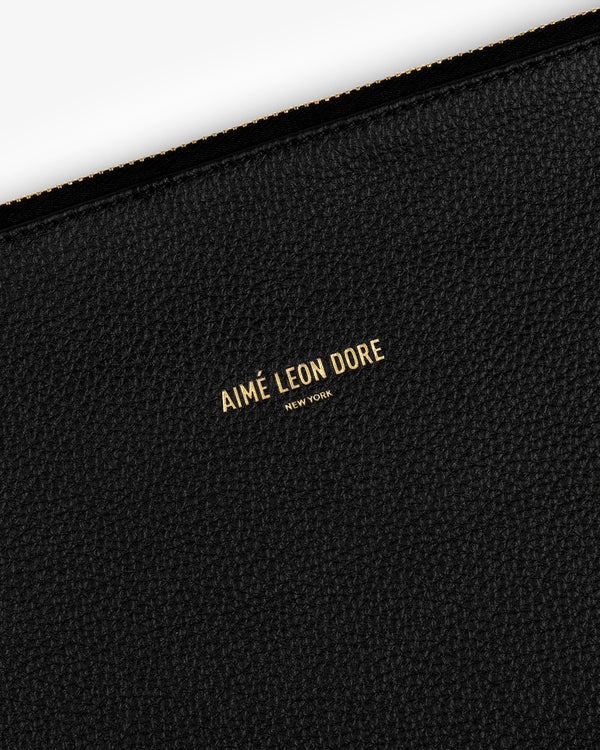 Black textured Small Leather Pouch with AIMÉ LEON DORE NEW YORK printed in gold at the center.