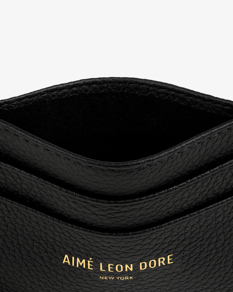 Leather Card Holder in black with gold AIMÉ LEON DORE NEW YORK text embossed on the front.