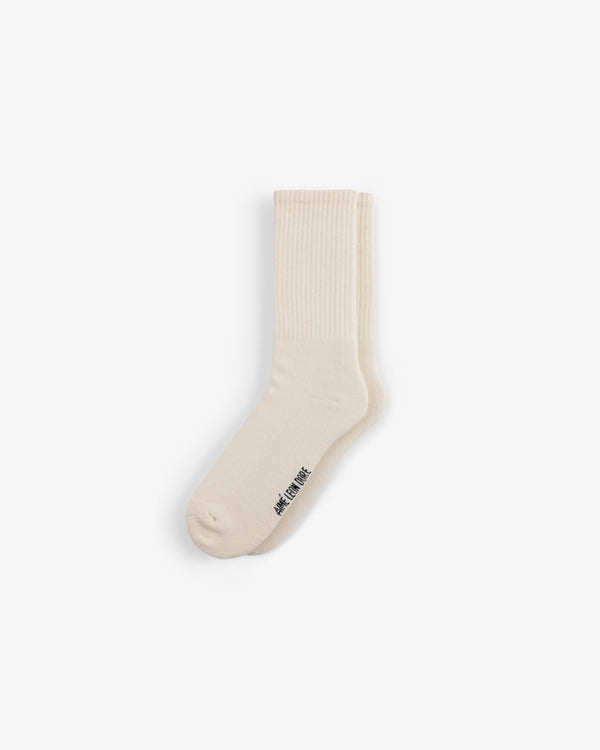 Crew Sock 3-Pack: cream crew socks with ribbed cuffs and small black text near the toe on a white background.