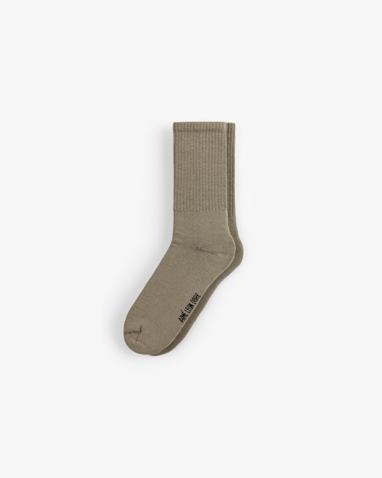 Crew Sock 3-Pack: Beige ribbed crew socks with small black text by the toe, shown on a white background.