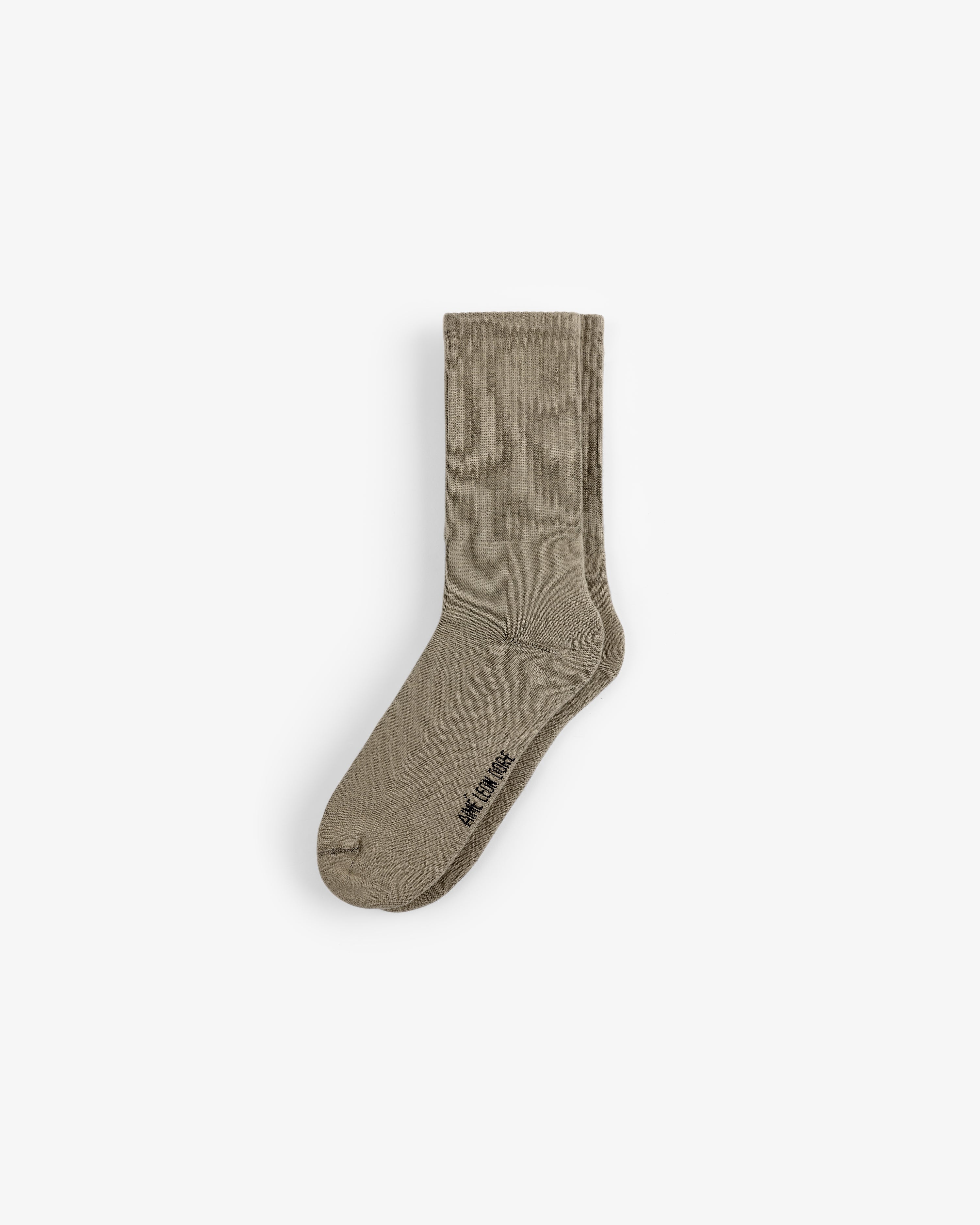 Crew Sock 3-Pack: Beige ribbed crew socks with small black text by the toe, shown on a white background.
