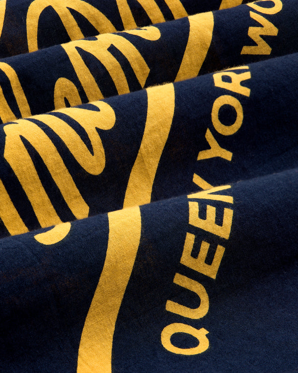 Navy blue Unisphere Bandana with bold yellow text; "QUEEN" is clearly visible among the fabric folds.