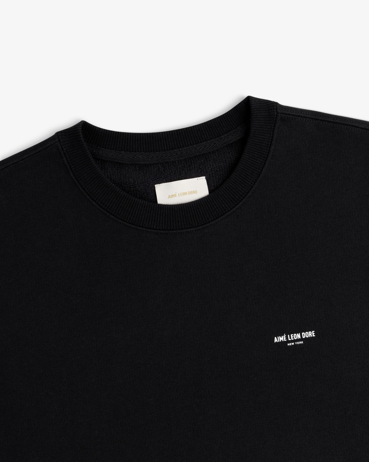 Black Micro Logo Crewneck Sweatshirt with small white AIMÉ LEON DORE text on left chest.