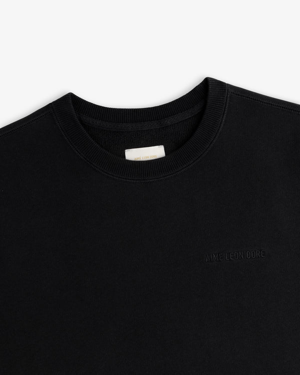 Tonal Logo Crewneck Sweatshirt in black with subtle embroidered logo and white collar label.