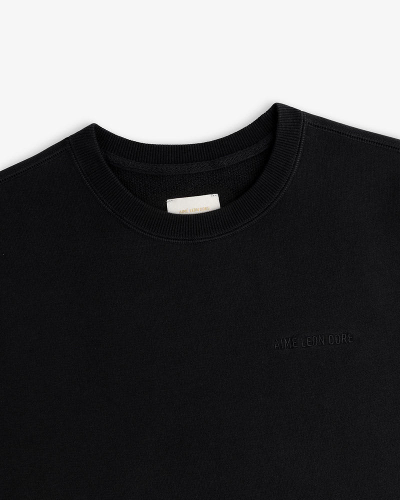 Tonal Logo Crewneck Sweatshirt in black with subtle embroidered logo and white collar label.