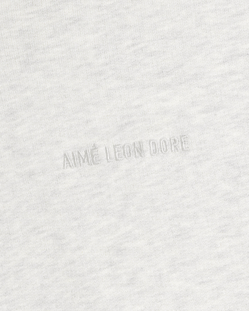 Close-up of Tonal Logo Crewneck Sweatshirt in light gray with AIMÉ LEON DORE subtly embossed at the center.
