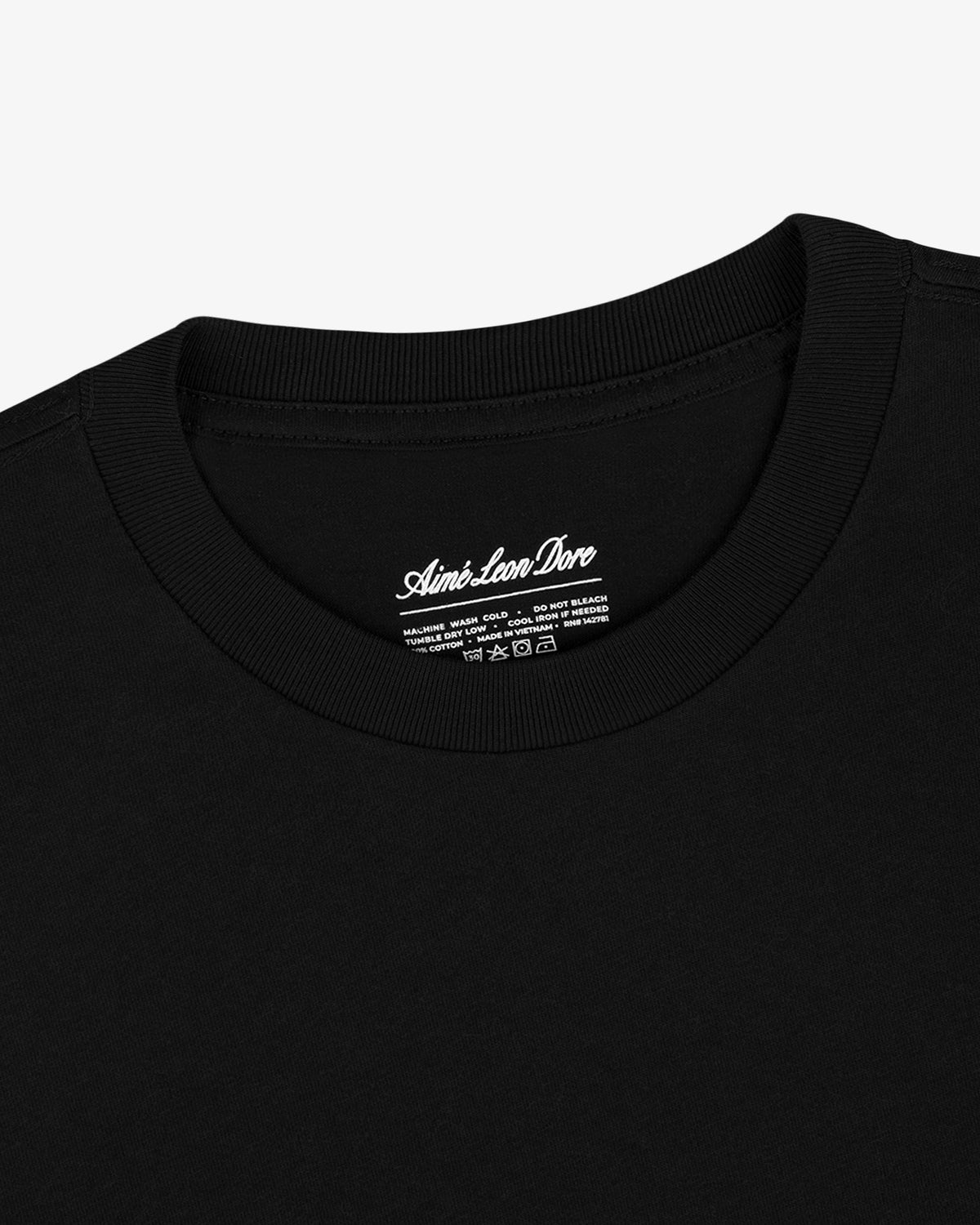 Close-up of a black crewneck T-Shirt 3-Pack with white branding and care instructions inside the collar.