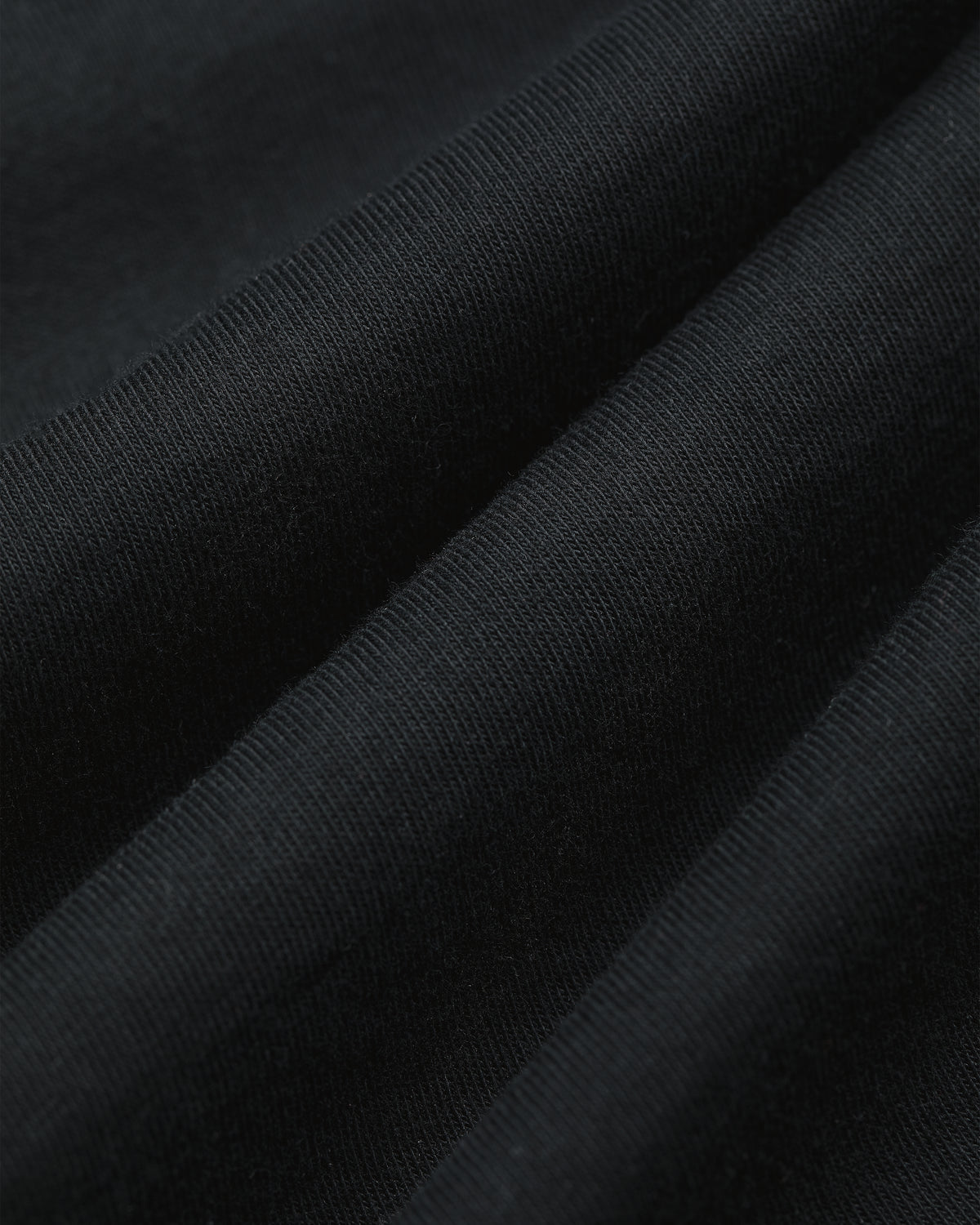Close-up of ribbed fabric from the Multi-Color T-Shirt 3-Pack, showing its textured diagonal folds.