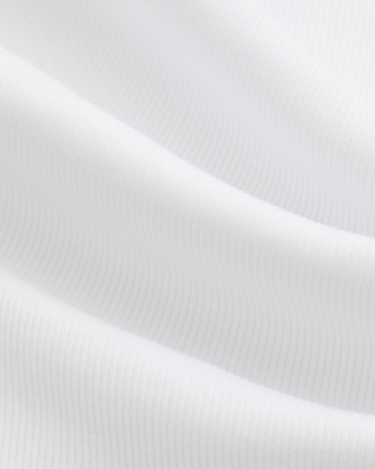 Close-up of white ribbed fabric with soft folds from the Tank Top 3-Pack.