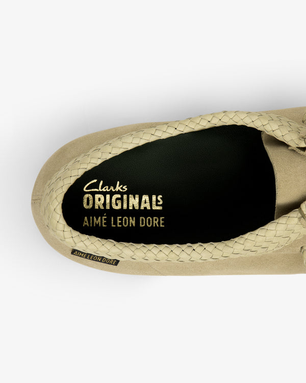 Top view of ALD / Clarks Suede Wallabee in beige with braided trim and branded insole.