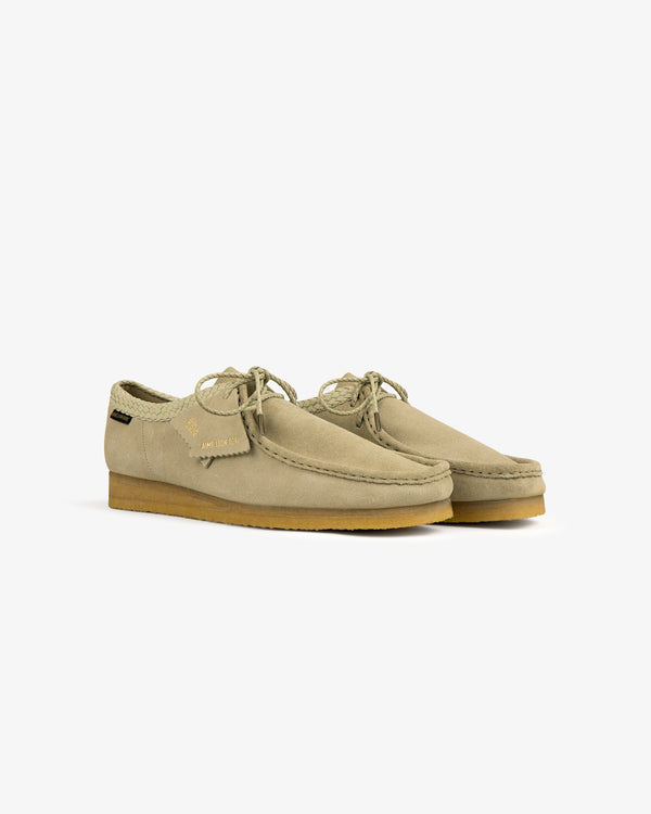 ALD / Clarks Suede Wallabee: beige moccasin shoes with crepe soles and laces on a white background.