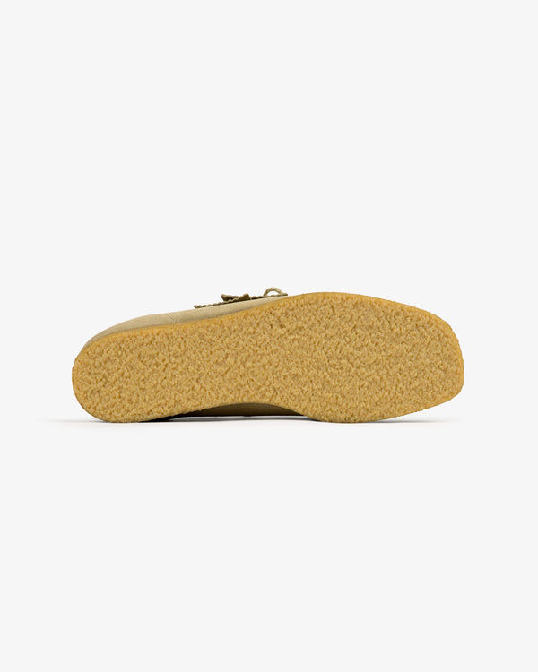 Bottom view of ALD / Clarks Suede Wallabee in beige, showing textured rubber sole on a plain white background.