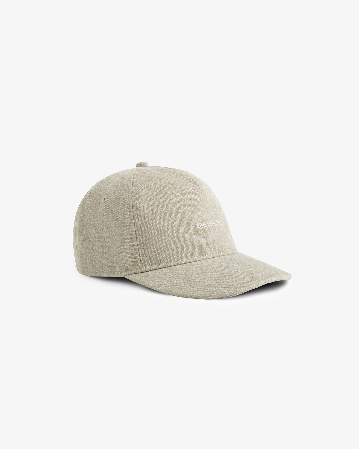 Micro Logo Hat in beige with curved brim, visible stitching, and subtle white text on front, on a white background.