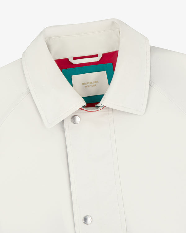 Sailing Jacket with silver snap buttons and a colorful inner tag featuring red, teal, and beige accents.