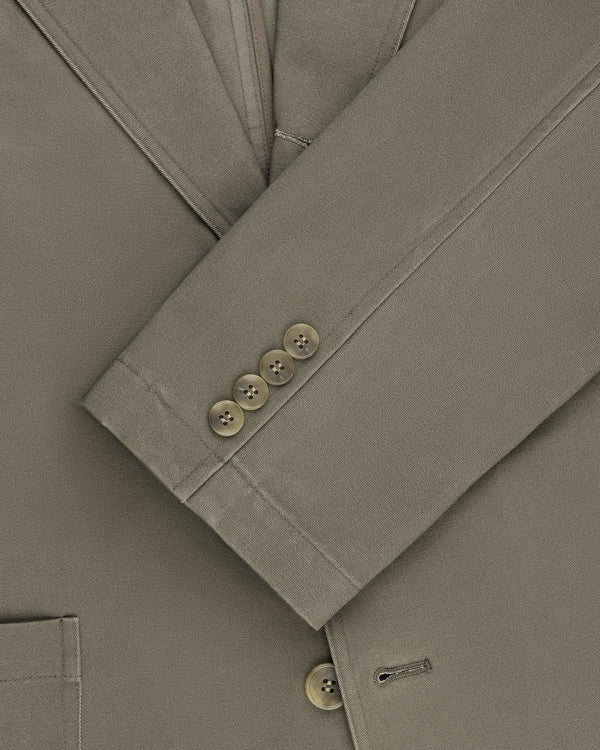 Close-up of Single-Breasted Washed Twill Suit Jacket sleeve in olive with four brown buttons and pocket detail.