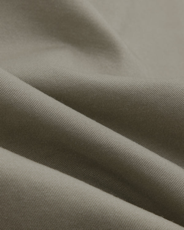 Close-up of Single-Breasted Washed Twill Suit Jacket in light brown, showing textured fabric and soft folds.